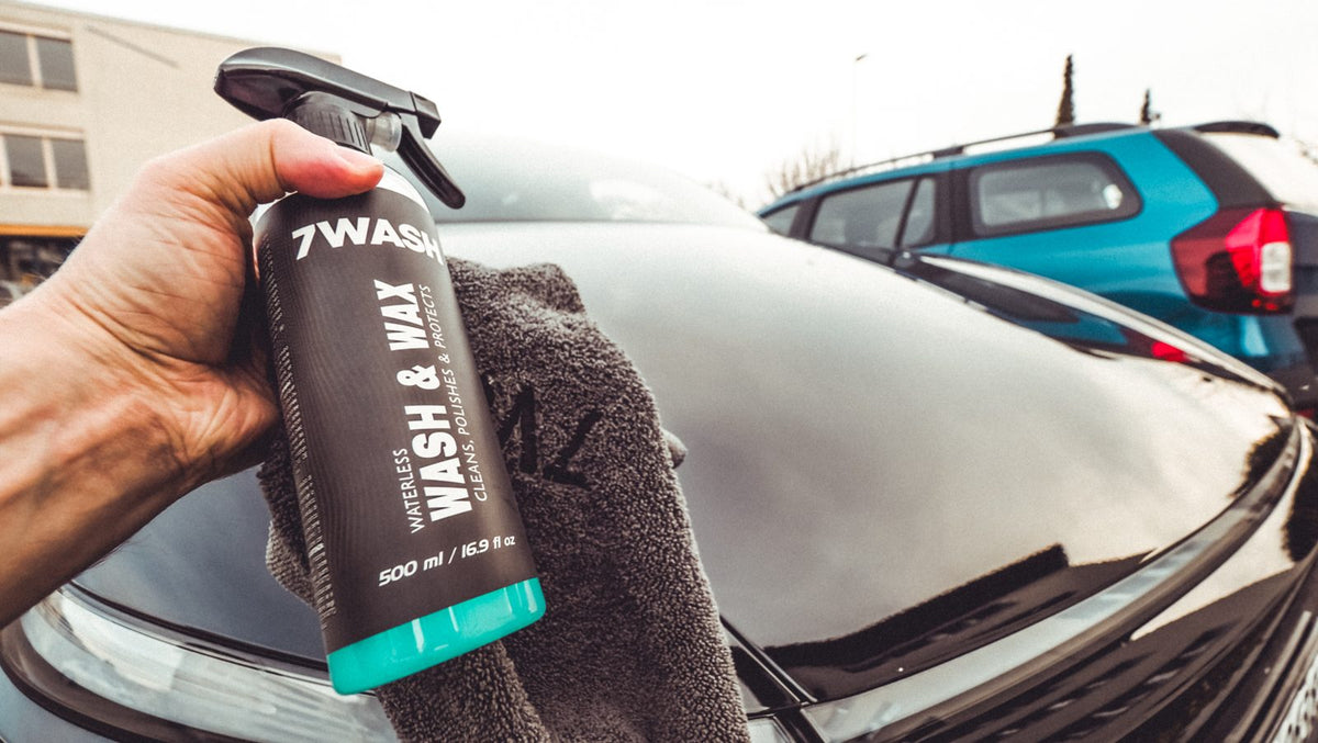 7WASH Waterless Wash & Wax spray bottle and microfiber cloth held over a car bonnet