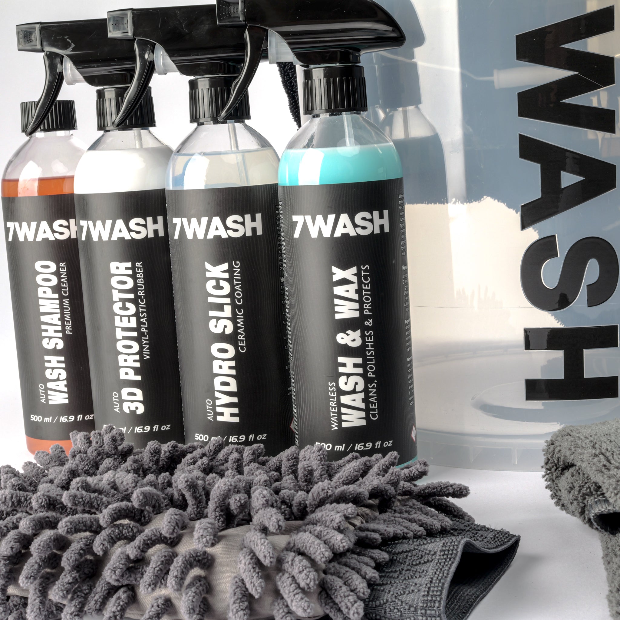 7WASH car detailing kit including a wash bucket, microfiber towels, wash mitt, foam applicator, and eight cleaning spray bottles featuring shampoo, wax, and interior cleaners.